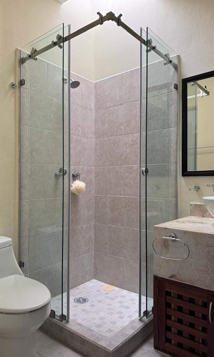 Chrome-railed corner frameless shower cubicle with grey tiles