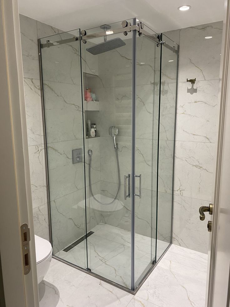 Sliding frameless shower enclosure with marble-look walls